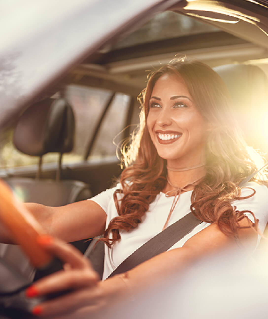 Happy woman driving car